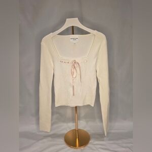 Elegant Cream Long Sleeve Top with Pink Ribbon